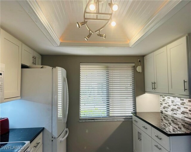 11460 Caravel Cir Unit 5009, Fort Myers, FL 33908 - kitchen featuring a raised ceiling, dark countertops, range, and white cabinets