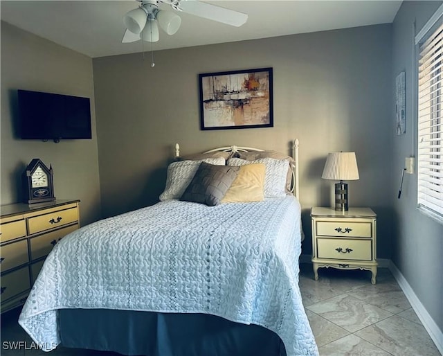11460 Caravel Cir Unit 5009, Fort Myers, FL 33908 - bedroom featuring marble look tile flooring, multiple windows, baseboards, and ceiling fan