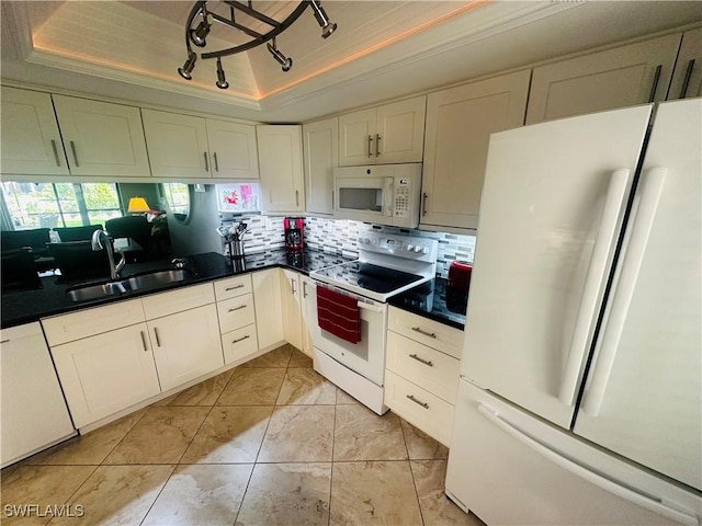 11460 Caravel Cir Unit 5009, Fort Myers, FL 33908 - kitchen with white appliances, a sink, a tray ceiling, dark countertops, and decorative backsplash