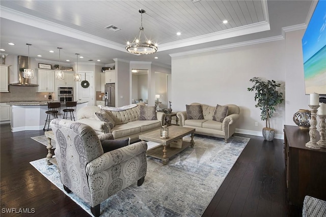 4551 Tamarind Way, Naples, FL 34119 - living room featuring a chandelier, dark wood-type flooring, baseboards, a raised ceiling, and ornamental molding