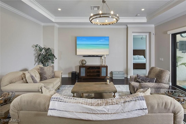 4551 Tamarind Way, Naples, FL 34119 - living room featuring a raised ceiling, a chandelier, wood finished floors, baseboards, and crown molding