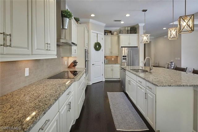 4551 Tamarind Way, Naples, FL 34119 - kitchen featuring a sink, stainless steel appliances, wall chimney range hood, ornamental molding, and white cabinets