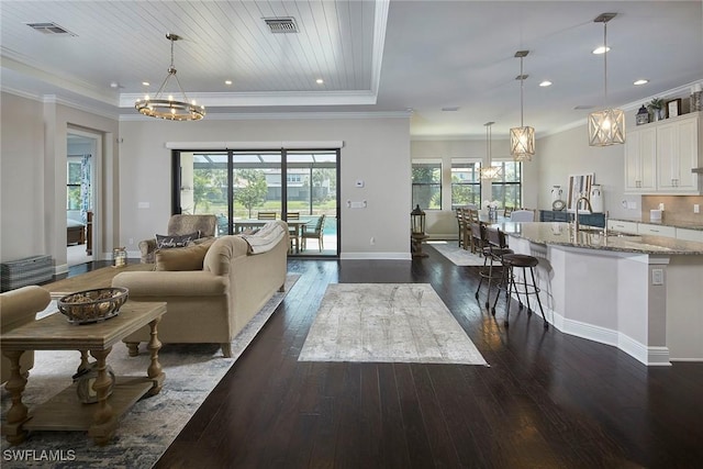 4551 Tamarind Way, Naples, FL 34119 - living room with a chandelier, dark wood finished floors, recessed lighting, baseboards, and ornamental molding