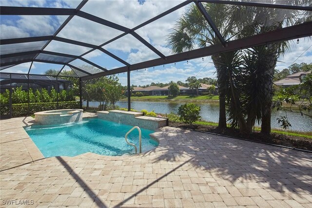 4551 Tamarind Way, Naples, FL 34119 - view of swimming pool featuring a patio, a water view, a pool with connected hot tub, and glass enclosure