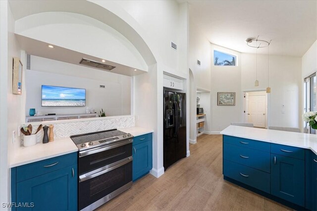 171 Via Napoli, Naples, FL 34105 - kitchen featuring double oven range, black refrigerator with ice dispenser, blue cabinets, light wood finished floors, and light countertops