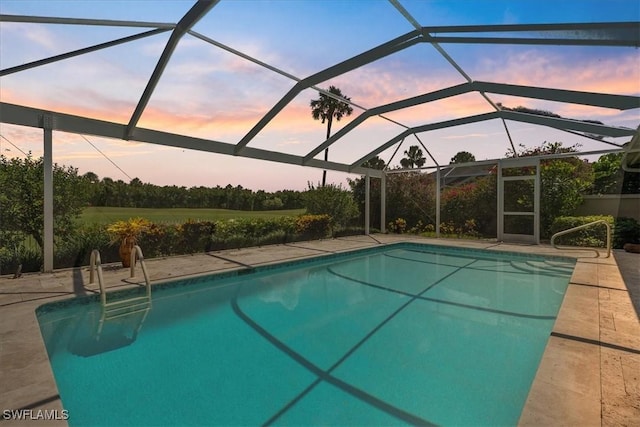 171 Via Napoli, Naples, FL 34105 - pool at dusk featuring an outdoor pool, a patio area, and a lanai