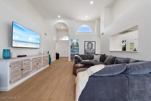 171 Via Napoli, Naples, FL 34105 - living room with light wood-type flooring, arched walkways, baseboards, and recessed lighting