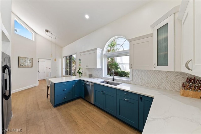 171 Via Napoli, Naples, FL 34105 - kitchen with appliances with stainless steel finishes, a sink, blue cabinetry, a peninsula, and white cabinets