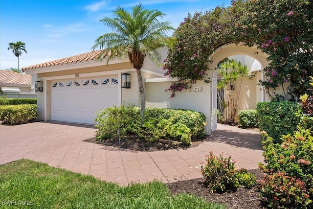 171 Via Napoli, Naples, FL 34105 - view of front facade featuring an attached garage, stucco siding, concrete driveway, and a tile roof