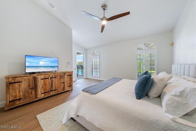 171 Via Napoli, Naples, FL 34105 - bedroom with multiple windows, vaulted ceiling, access to outside, wood finished floors, and ceiling fan