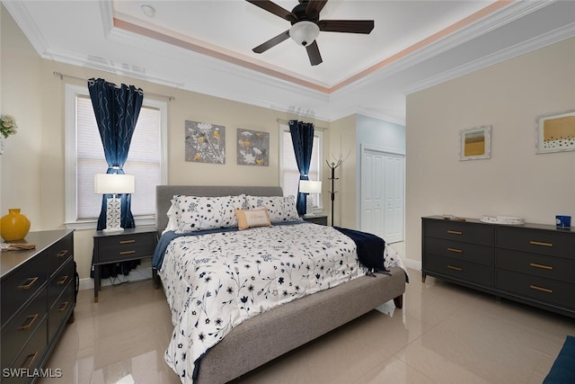 3460 4th Ave NE, Naples, FL 34120 - bedroom with a raised ceiling, a closet, ornamental molding, baseboards, and light tile patterned floors