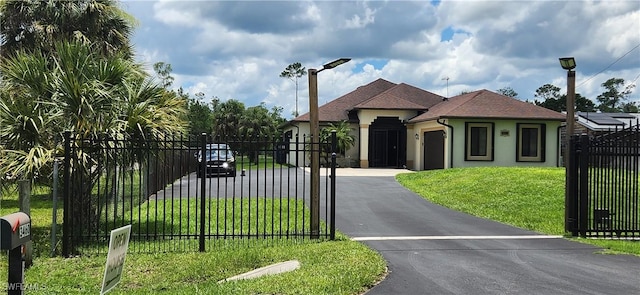 3460 4th Ave NE, Naples, FL 34120 - view of front of house featuring a garage, driveway, stucco siding, a gate, and a fenced front yard