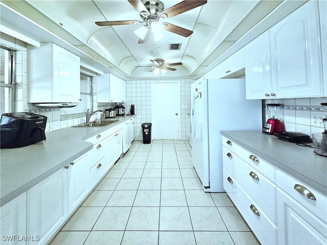 4268 25th Ave SW, Naples, FL 34116 - kitchen with a sink, light tile patterned floors, ceiling fan, white cabinetry, and freestanding refrigerator