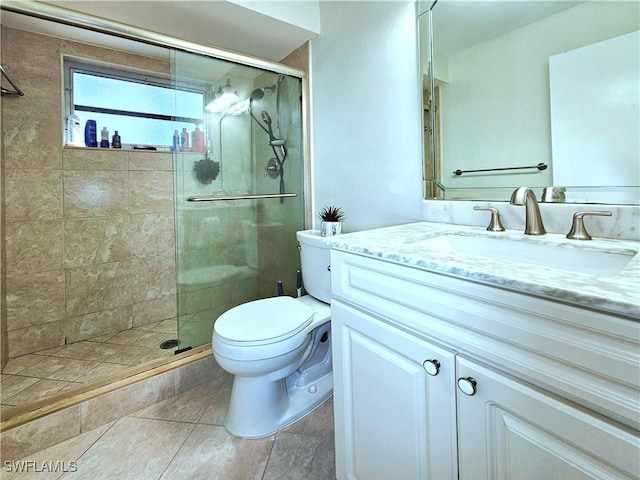 4268 25th Ave SW, Naples, FL 34116 - full bath with vanity, toilet, a stall shower, and tile patterned flooring