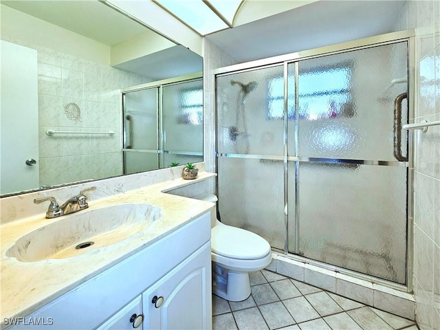 4268 25th Ave SW, Naples, FL 34116 - full bathroom with tile patterned floors, vanity, toilet, and a shower stall