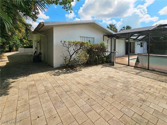 4268 25th Ave SW, Naples, FL 34116 - rear view of house featuring a patio area, an outdoor pool, stucco siding, and a lanai