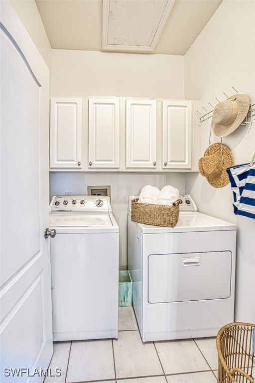 15055 Tamarind Cay Ct Unit 1205, Fort Myers, FL 33908 - laundry area featuring cabinet space, washer and dryer, light tile patterned floors, and attic access