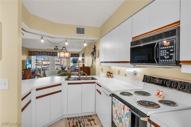 991 N Barfield Dr Unit 110, Marco Island, FL 34145 - kitchen with white electric range oven, black microwave, track lighting, a sink, and light countertops