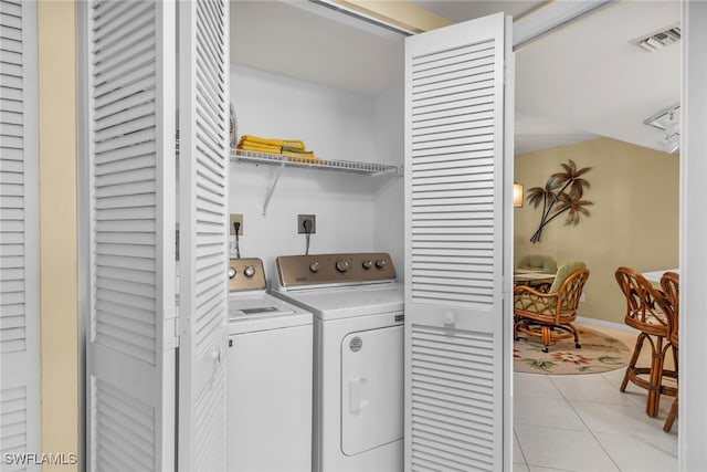 991 N Barfield Dr Unit 110, Marco Island, FL 34145 - laundry room with separate washer and dryer, light tile patterned flooring, and baseboards