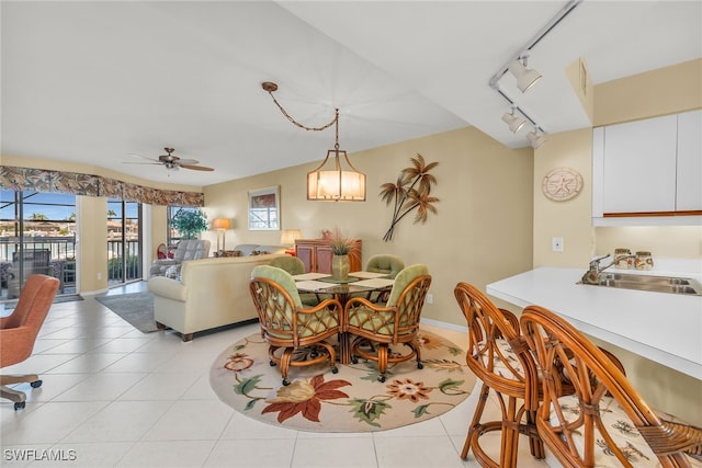 991 N Barfield Dr Unit 110, Marco Island, FL 34145 - dining area featuring rail lighting, ceiling fan, light tile patterned floors, and baseboards