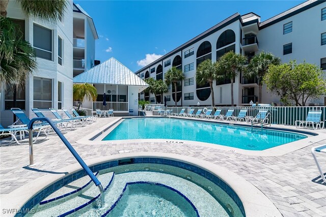 991 N Barfield Dr Unit 110, Marco Island, FL 34145 - community pool with a community hot tub and a patio area