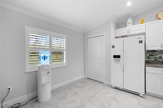 1187 16th Ave NE, Naples, FL 34120 - kitchen featuring white fridge with ice dispenser, crown molding, white cabinetry, and baseboards