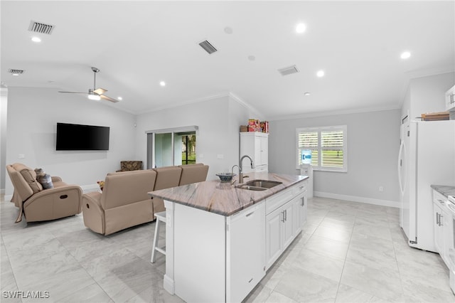 1187 16th Ave NE, Naples, FL 34120 - kitchen featuring a sink, white appliances, light marble finish flooring, light stone counters, and a kitchen island with sink
