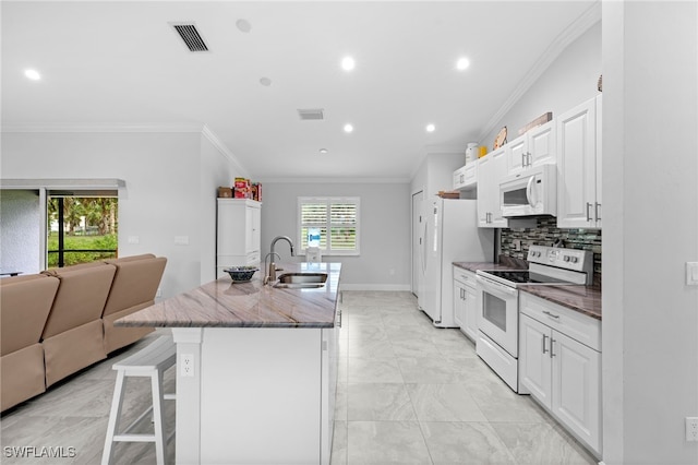 1187 16th Ave NE, Naples, FL 34120 - kitchen featuring white appliances, a sink, ornamental molding, a breakfast bar, and a kitchen island with sink