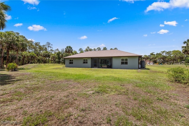 1187 16th Ave NE, Naples, FL 34120 - back of house with a yard and stucco siding