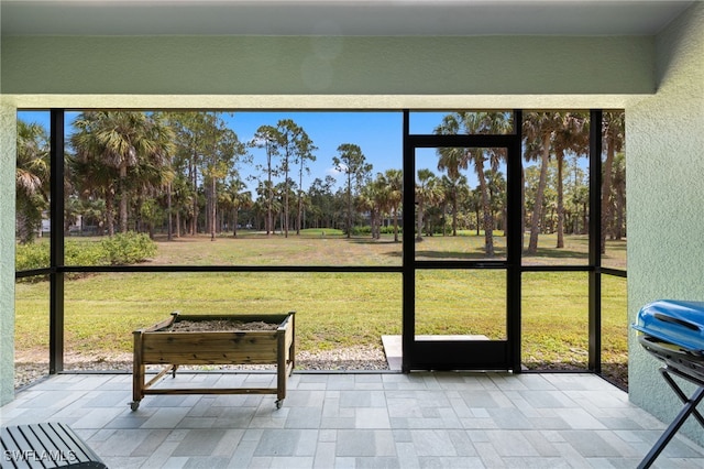 1187 16th Ave NE, Naples, FL 34120 - sunroom / solarium featuring view of scattered trees