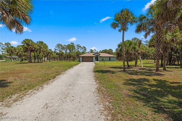 1187 16th Ave NE, Naples, FL 34120 - view of front of property with a front lawn, driveway, and an attached garage