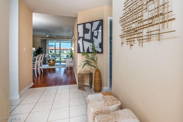 6900 Huntington Lakes Cir Unit 102, Naples, FL 34119 - hallway featuring baseboards and tile patterned floors