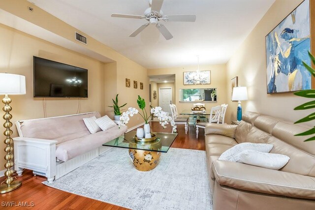 6900 Huntington Lakes Cir Unit 102, Naples, FL 34119 - living room featuring wood finished floors, a chandelier, and ceiling fan