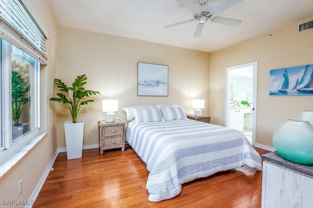6900 Huntington Lakes Cir Unit 102, Naples, FL 34119 - bedroom featuring wood finished floors, baseboards, ensuite bath, and ceiling fan