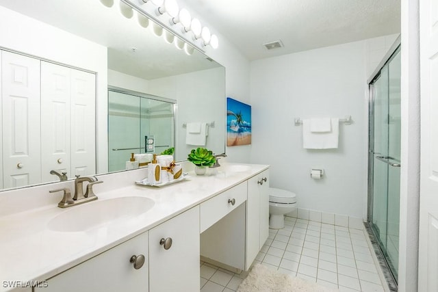 6900 Huntington Lakes Cir Unit 102, Naples, FL 34119 - full bath featuring double vanity, a shower stall, toilet, tile patterned flooring, and baseboards