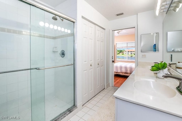 6900 Huntington Lakes Cir Unit 102, Naples, FL 34119 - bathroom with vanity, a stall shower, tile patterned floors, and ensuite bath