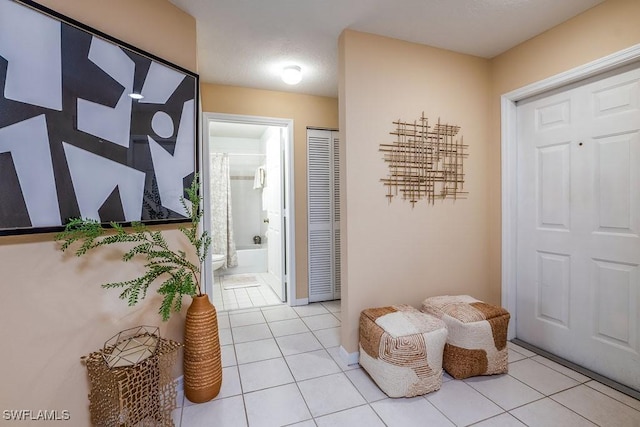 6900 Huntington Lakes Cir Unit 102, Naples, FL 34119 - corridor featuring light tile patterned flooring and baseboards
