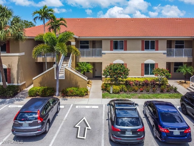 6900 Huntington Lakes Cir Unit 102, Naples, FL 34119 - view of property with uncovered parking and stairway