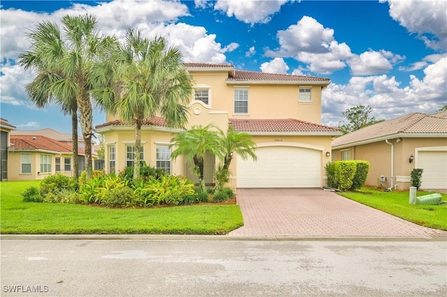 10212 Mimosa Silk Dr, Fort Myers, FL 33913 - view of front facade with a tiled roof, stucco siding, decorative driveway, and an attached garage