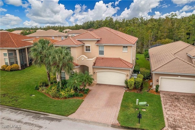 10212 Mimosa Silk Dr, Fort Myers, FL 33913 - mediterranean / spanish-style home with decorative driveway, stucco siding, and a tiled roof