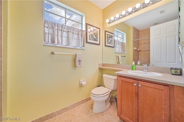 10212 Mimosa Silk Dr, Fort Myers, FL 33913 - bathroom featuring toilet, tiled shower, vanity, tile patterned floors, and baseboards