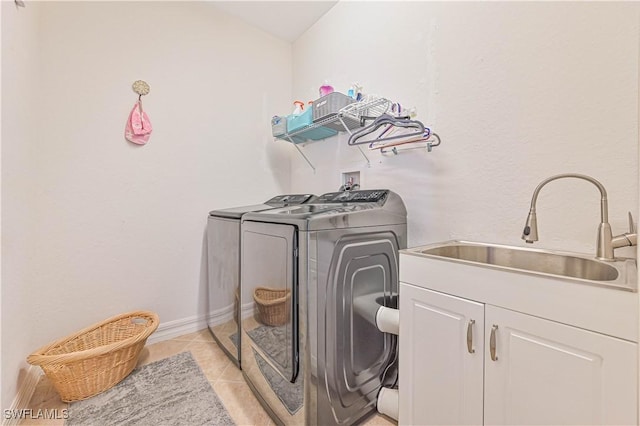 10212 Mimosa Silk Dr, Fort Myers, FL 33913 - washroom featuring washing machine and dryer, cabinet space, baseboards, and light tile patterned flooring