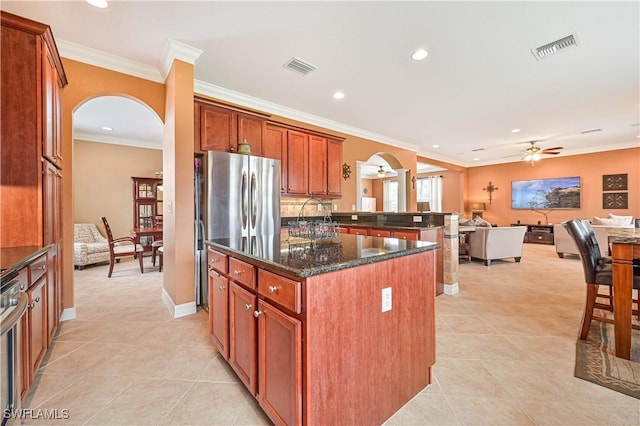 10212 Mimosa Silk Dr, Fort Myers, FL 33913 - kitchen with arched walkways, open floor plan, a ceiling fan, light tile patterned floors, and recessed lighting