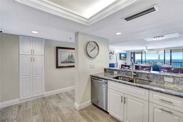100 N Collier Blvd Unit 1002, Marco Island, FL 34145 - kitchen featuring stainless steel dishwasher, a sink, light stone counters, light wood-type flooring, and baseboards