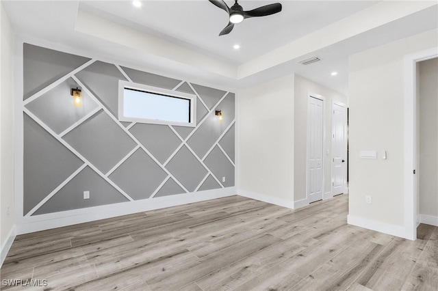 224 NW 14th Pl, Cape Coral, FL 33993 - unfurnished room with a ceiling fan, wood finished floors, baseboards, recessed lighting, and a raised ceiling