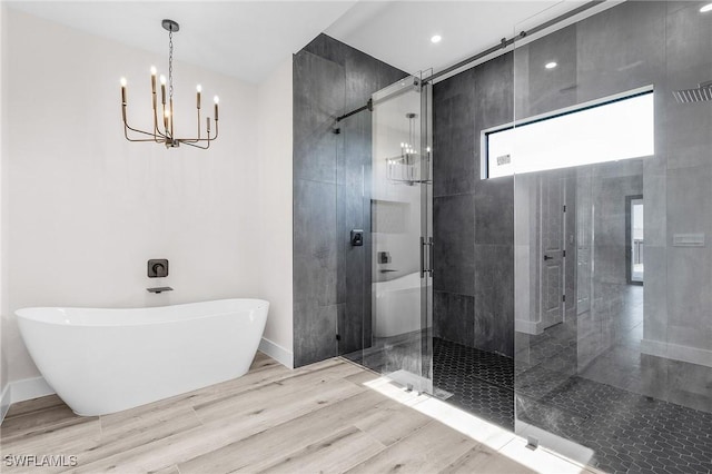 224 NW 14th Pl, Cape Coral, FL 33993 - bathroom with a chandelier, a shower stall, a freestanding tub, and baseboards