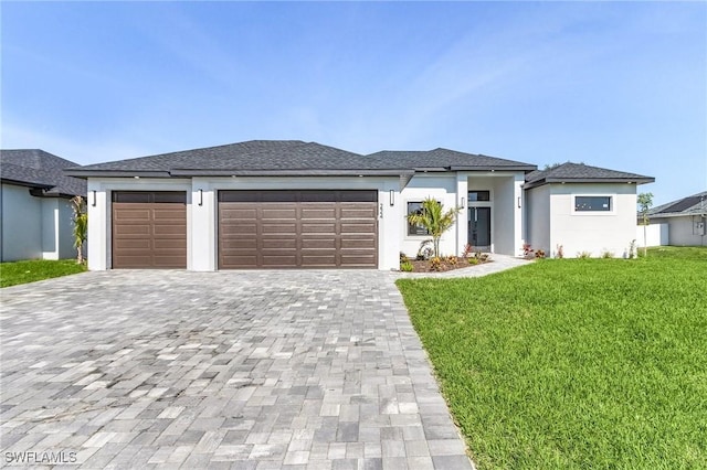 224 NW 14th Pl, Cape Coral, FL 33993 - prairie-style home with decorative driveway, a garage, and a front yard