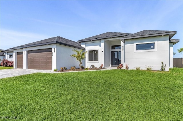 224 NW 14th Pl, Cape Coral, FL 33993 - prairie-style house featuring a garage, a front yard, decorative driveway, and stucco siding