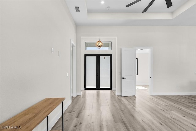 224 NW 14th Pl, Cape Coral, FL 33993 - entrance foyer with a tray ceiling, ceiling fan, french doors, light wood-type flooring, and baseboards