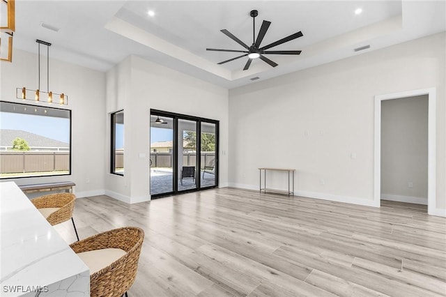 224 NW 14th Pl, Cape Coral, FL 33993 - unfurnished living room with a raised ceiling, ceiling fan, wood finished floors, baseboards, and recessed lighting